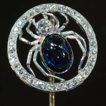 Sparkling spider in Art Deco tie pin with sugar loaf cabochon cut sapphire